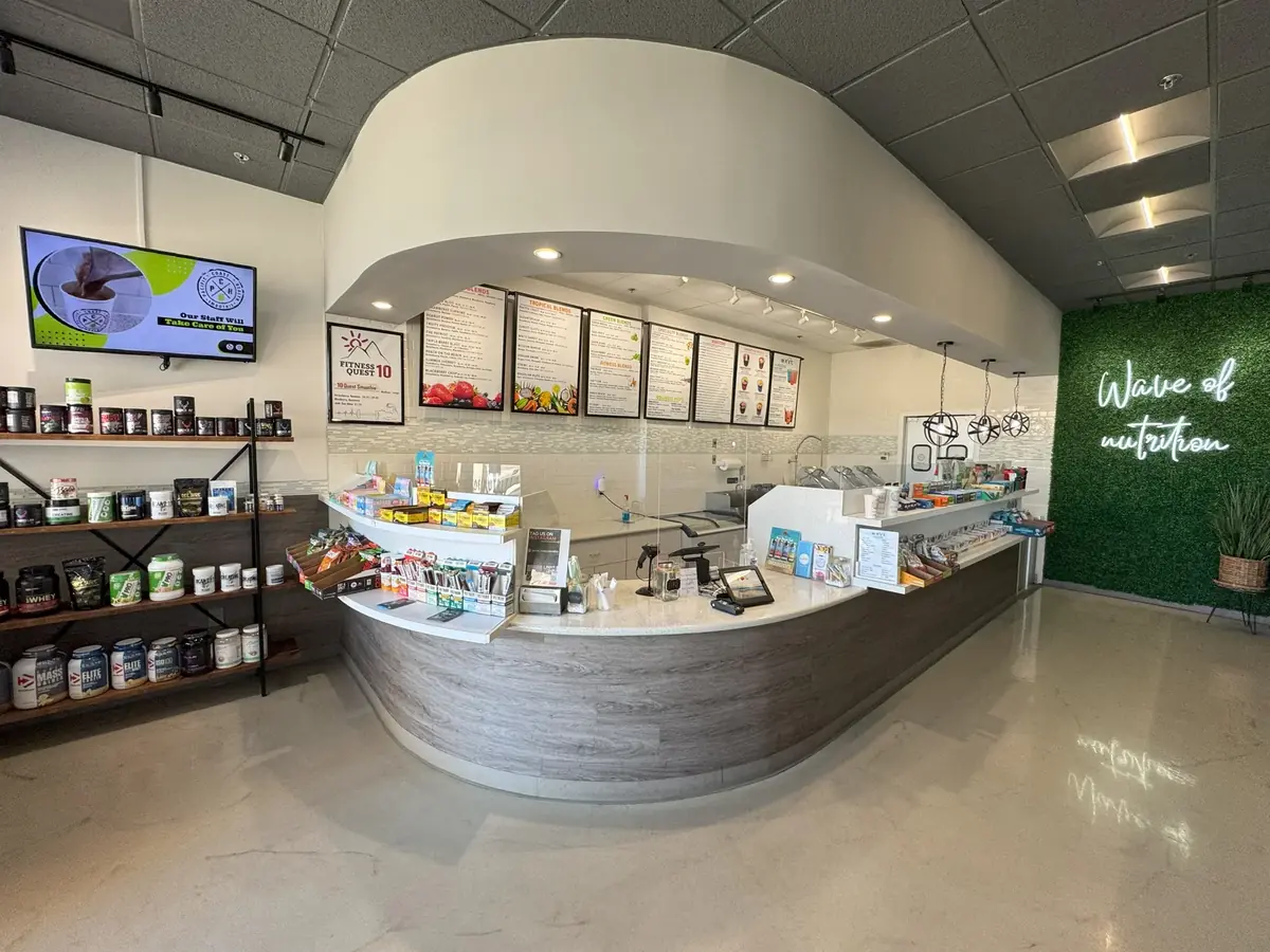 Pacific Coast Health Smoothie shop interior in San Diego with menu board and supplement shelves