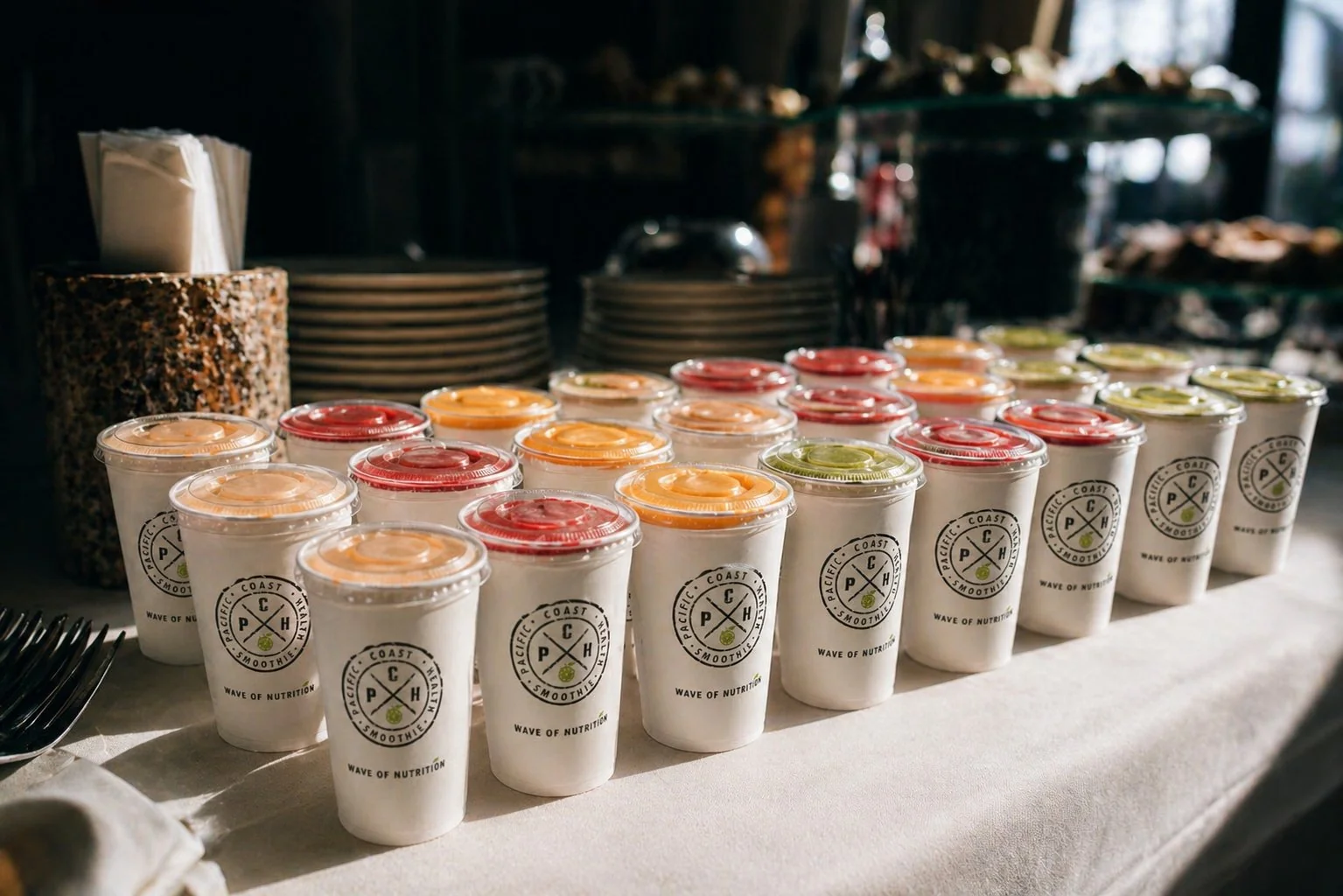 Pacific Coast Health Smoothie cups arranged on an elegant banquet table for a wedding or corporate event
